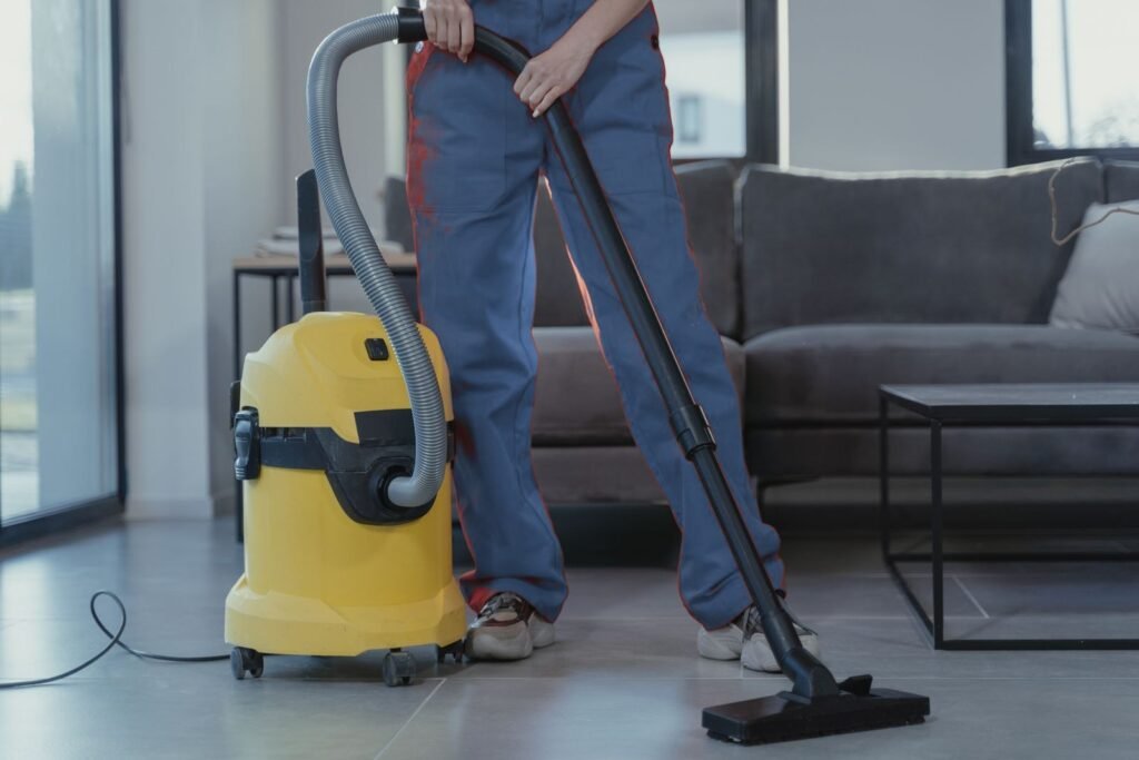Professional cleaner wiping a surface during a home cleaning visit